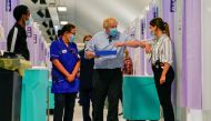 Britain's Prime Minister Boris Johnson greets a woman during a visit in a vaccination centre at the StoneX Stadium, home of the rugby club Saracens, amid coronavirus disease (COVID-19) pandemic, in North London, Britain June 21, 2021. Alberto Pezzali/Pool