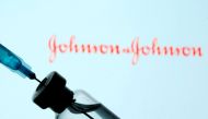 A vial and syringe are seen in front of a displayed Johnson & Johnson logo in this illustration taken January 11, 2021. REUTERS/Dado Ruvic/Illustration/File Photo
