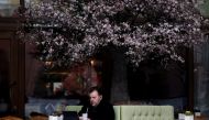A man uses a tablet as he sits on a terrace at a cafe in Moscow, Russia March 23, 2021. REUTERS/Maxim Shemetov/File Photo