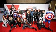 Fans dressed as Avengers characters pose for a picture during a special fan event for the Marvel film 