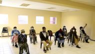 FILE PHOTO: People wearing protective masks sit ahead of a vaccination, as South Africa rolls out the coronavirus disease (COVID-19) vaccines to the elderly at the Munsieville Care for the Aged Centre outside Johannesburg, South Africa May 17, 2021. REUTE