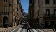 FILE PHOTO: A person wearing a protective mask walks in Lisbon downtown amid the coronavirus disease (COVID-19) pandemic, in Lisbon, Portugal, June 24, 2021. REUTERS/Pedro Nunes/File Photo
