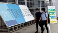 People walk past a sign advertising the 2020 Tokyo Olympic Games that have been postponed to 2021 due to the coronavirus disease (COVID-19) pandemic during the opening of the IBC/MPC media center at Tokyo Big Sight exhibition center in Tokyo, Japan July 1