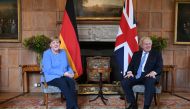 German Chancellor Angela Merkel poses with Britain's Prime Minister Boris Johnson before their bilateral meeting at Chequers, the official country residence of the Prime Minister, near Aylesbury, Buckinghamshire, Britain July 2, 2021. Stefan Rousseau/Pool