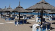 Unoccupied beach lounge chairs are seen on a half empty beach by the Mediterranean Sea, amid the coronavirus disease (COVID-19) pandemic, in Fuengirola, southern Spain, May 25, 2021. REUTERS/Jon Nazca