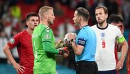 Denmark's Kasper Schmeichel talks to referee Danny Makkelie before he awards England a penalty after a VAR review Pool via REUTERS/Andy Rain