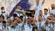  July 10, 2021 Argentina's Lionel Messi and teammates celebrate winning the Copa America with the trophy REUTERS/Amanda Perobelli