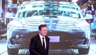 FILE PHOTO: Tesla Inc CEO Elon Musk walks next to a screen showing an image of Tesla Model 3 car during an opening ceremony for Tesla China-made Model Y program in Shanghai, China January 7, 2020. REUTERS/Aly Song