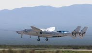 Virgin Galactic's passenger rocket plane VSS Unity, borne by twin-fuselage carrier jet dubbed VMS Eve, takes off with billionaire entrepreneur Richard Branson and his crew for travel to the edge of space at Spaceport America near Truth or Consequences, Ne