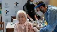 FILE PHOTO: An elderly woman claps her hands after receiving a vaccine against the coronavirus at a nursing home in Athens, Greece, January 25, 2021/REUTERS