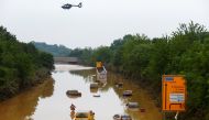 A helicopter flies above cars partially submerged in floodwaters on the road following heavy rainfalls in Erftstadt-Blessem, Germany, July 17, 2021. REUTERS/Thilo Schmuelgen
