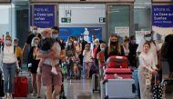 British tourists wearing protective face masks walk with their luggage, as they arrive at Malaga-Costa del Sol Airport for sightseeing, amid the coronavirus disease (COVID-19) outbreak in Malaga, Spain, July 19, 2021. REUTERS/Jon Nazca
