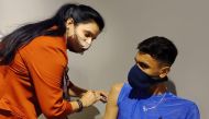 An athlete gets the COVID-19 vaccination. 