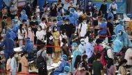 People line up for nucleic acid testing at a sports centre in Gulou district, during a citywide mass testing following new cases of the coronavirus disease (COVID-19) in Nanjing, Jiangsu province, China July 22, 2021. cnsphoto via REUTERS