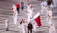 Flag bearers Tala Abujbara and Mohammed Al Rumaihi of Qatar lead their contingent during the athletes parade at the opening ceremony of the Olympics at the Olympic Stadium in Tokyo, Japan, yesterday.