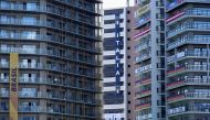 Flags and banners hang at apartment buildings in the athletes' village for the Tokyo 2020 Olympic Games, in Tokyo, Japan, July 22, 2021. REUTERS/Naoki Ogura
