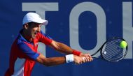 July 24, 2021. Novak Djokovic of Serbia in action during his first round match against Hugo Dellien of Bolivia REUTERS/Mike Segar