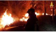 A firefighter battles the flames after a wildfire broke out near the Sicilian village of Erice, Italy July 26, 2021. Vigili del Fuoco/Handout via REUTERS