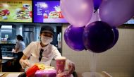 An employee of McDonald's serves a BTS meal, which is inspired and promoted by K-pop boy band BTS, during lunch hour at its restaurant in Seoul, South Korea, May 27, 2021. REUTERS/Kim Hong-Ji/File Photo