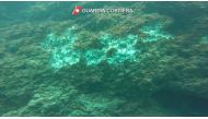 A general view of underwater damaged rocks after scuba divers used hammers to illegally harvest date mussels at Tyrrhenian Sea as seen in this screengrab taken from a video released on July 28, 2021. Italian Coast Guard/Handout via REUTERS