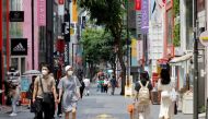 People wearing masks walk in a shopping district amid the coronavirus disease (COVID-19) pandemic in Seoul, South Korea, July 9, 2021. REUTERS/ Heo Ran/File Photo