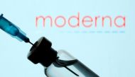 A vial and syringe are seen in front of a displayed Moderna logo in this illustration taken January 11, 2021. REUTERS/Dado Ruvic/Illustration/File Photo
