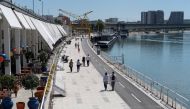 People walk by the bank of Sava river in Belgrade, Serbia, May 13, 2020. Picture taken May 13, 2020. REUTERS/Marko Djurica/File Photo