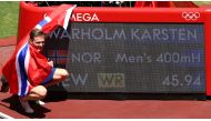  Karsten Warholm of Norway poses next to his new world record as he celebrates after winning gold. Reuters/Andrew Boyers