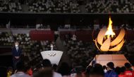 Tokyo 2020 President Seiko Hashimoto delivers a speech in front of the Olympic torch. (REUTERS/Dan Mullan)