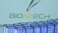 Test tubes are seen in front of a displayed Biontech logo in this illustration taken, May 21, 2021. REUTERS/Dado Ruvic/Illustration/File Photo