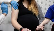 A pregnant woman receives a vaccine for the coronavirus disease (COVID-19) at Skippack Pharmacy in Schwenksville, Pennsylvania, U.S., February 11, 2021. REUTERS/Hannah Beier/File Photo