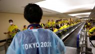 FILE PHOTO: Members of Australian team wait to take the quantitative coronavirus disease (COVID-19) antigen test after arriving at Narita International Airport ahead of Tokyo 2020 Olympic Games, in Narita, east of Tokyo, Japan July 17, 2021. REUTERS/Issei
