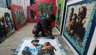 Ivorian painter Aristide Kouame 26, who paints optical effects artworks with worn soles, works at his workshop in Abidjan, Ivory Coast August 4, 2021. Picture taken August 4, 2021. REUTERS/Luc Gnago