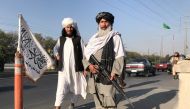 FILE PHOTO: A Taliban fighter holding an M16 assault rifle stands outside the Interior Ministry in Kabul, Afghanistan, August 16, 2021.REUTERS/Stringer