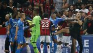 Pitch invaders clash with players as the game is interrupted REUTERS/Eric Gaillard