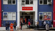 FILE PHOTO: People wait in line outside a coronavirus disease (COVID-19) vaccination clinic in the Bankstown suburb during a lockdown to curb an outbreak of cases in Sydney, Australia, August 25, 2021. REUTERS/Loren Elliott/File Photo
