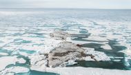 An undated handout image with a view of a tiny island off the coast of Greenland, discovered during the Leister Expedition, which they say is the world's northernmost point of land. Julian Charriere/via REUTERS