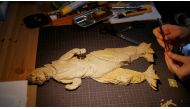 A cardboard sculpture of Godzilla is seen on the desk of 29-year-old artist Monami Ohno in Tokyo, Japan August 25, 2021. Picture taken August 25, 2021. REUTERS/Joseph Campbell