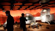 People inspect models of a Mars base and a rover displayed inside the SKP-S shopping mall in Beijing, China September 23, 2020. REUTERS/Tingshu Wang/File Photo