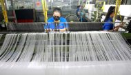 Women work in a weaving factory, as Bangkok city administration and temples drive efforts to encourage the public to donate plastic bottles, which will be collected and upcycled into reusable Personal Protective Equipment (PPE) to reduce plastic waste as 