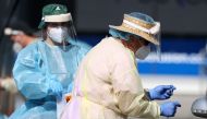 A medical worker administers a COVID-19 test at a testing clinic during a lockdown to curb the spread of a coronavirus disease (COVID-19) outbreak in Auckland, New Zealand, August 26, 2021. REUTERS/Fiona Goodall
