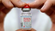FILE PHOTO: Walmart pharmacist holds a vial of the Moderna coronavirus disease (COVID-19) vaccine inside a Walmart department store in West Haven, Connecticut, U.S., February 17, 2021. REUTERS/Mike Segar/File Photo
