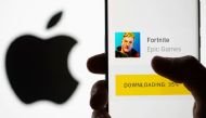 Fortnite game download on Android operating system is seen in front of Apple logo in this illustration taken, May 2, 2021. REUTERS/Dado Ruvic/Illustration
