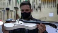 Luthier Ivan Oliveira crafts a violin from PVC piping for Locomotiva Project, a free music school for at-risk children, in Santo Andre, Brazil August 4, 2021. Picture taken August 4, 2021. REUTERS/Carla Carniel