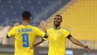 Al Gharafa captain Moyad Hassan celebrates with team-mate Ahmed Al Janehi after scoring their second goal against Al Shamal at Al Gharafa Stadium, yesterday.