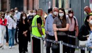 People queue to receive a vaccine against the coronavirus disease (COVID-19), during a night of vaccinations with music, at the Arena Treptow vaccination centre in Berlin, Germany, August 9, 2021. John Macdougall/Pool via REUTERS/File Photo