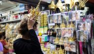 A customer looks for Thai traditional costume head gear similar to one wore by Thai-born K-pop singer Lalisa 