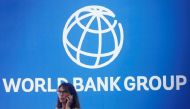 A participant stands near a logo of World Bank at the International Monetary Fund - World Bank Annual Meeting 2018 in Nusa Dua, Bali, Indonesia, October 12, 2018. REUTERS/Johannes P. Christo