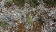 Plastic bottles are seen in a ditch where floodwaters have receded following heavy rainfall in Xinxiang, Henan province, China July 25, 2021. REUTERS/Aly Song