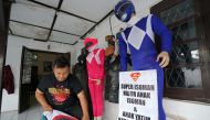 Agus Widanarko, 40, puts on a Spiderman costume as he prepares to entertain children confined to their homes due to coronavirus disease (COVID-19) restrictions, in Sukoharjo, Central Java province, Indonesia, September 10, 2021. REUTERS/Stringer